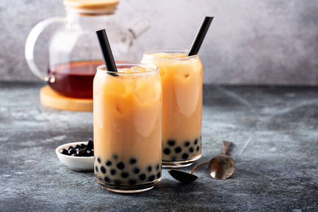 Image of two boba milk tea drinks in a glass